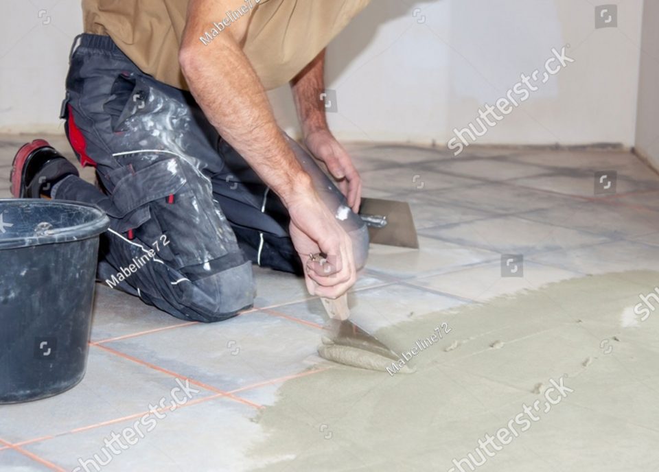 Sub floor stock photo construction worker leveling compound with putty knife renovation floor leveling screed mass 2091770284
